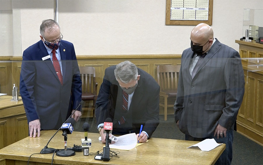 Gov. Little signs the Wrongful Conviction Act into law alongside Chris Tapp - Vimarsana News