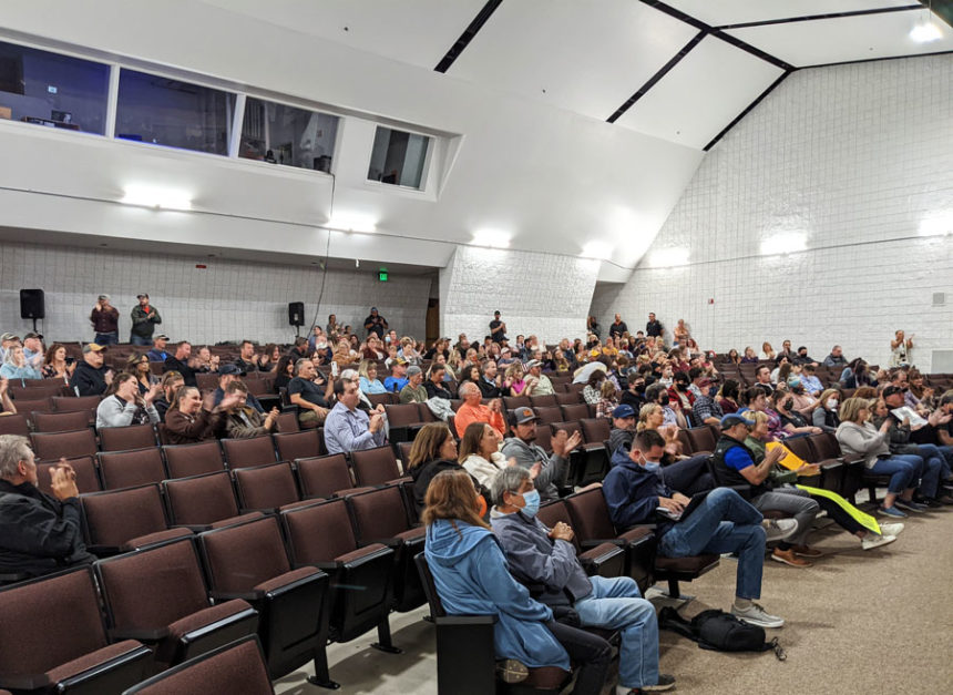 Attendees applaud as the board votes to approve the 2021-22 roadmap keeping masks optional